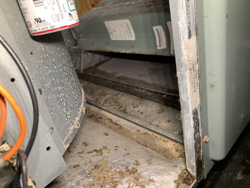 Responded to no cooling complaint on third floor system. Upon inspection, found return air filter extremely clogged with heavy dust and debris accumulation, severely restricting airflow to the unit. Removed and replaced dirty filter, cleared accumulated debris from filter housing and cabinet interior which showed significant rust staining and contamination. System restored to proper operation with adequate airflow after filter replacement and cleaning.