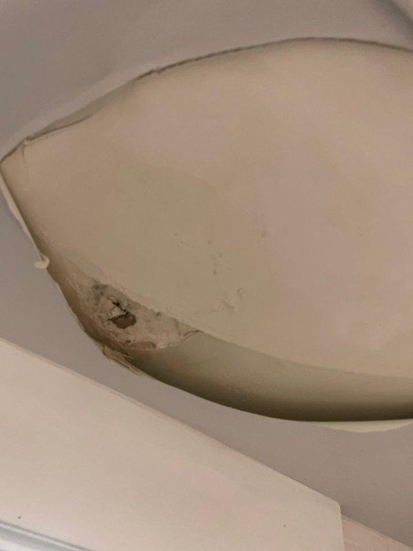 Responded to service call for air conditioner leaking water into bathroom. Upon inspection, found HVAC unit in attic space was not level, causing condensate drain pan to overflow and leak through ceiling into bathroom below. Leveled unit using appropriate shimming techniques and verified proper pitch for condensate drainage. Inspected drain line for blockages, cleared primary drain line, and tested system operation to confirm water was draining correctly. Checked secondary drain pan and overflow switch functionality. Verified no further water leakage occurring. System restored to proper operation with condensate draining as designed.
