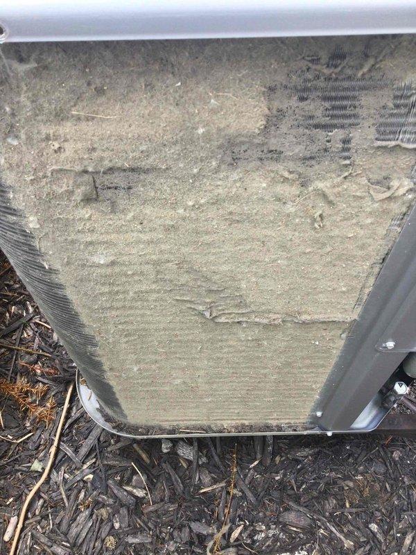 Responded to no-cool complaint on 13-year-old upstairs system. Upon arrival, found outdoor condensing unit with heavily soiled condenser coil exhibiting significant dirt accumulation, organic growth, and environmental debris buildup restricting airflow. Coil fins showed brownish-green staining and dust accumulation on both exterior surfaces and underside of unit. Documented equipment condition with photos showing extent of contamination affecting heat transfer efficiency and system performance.