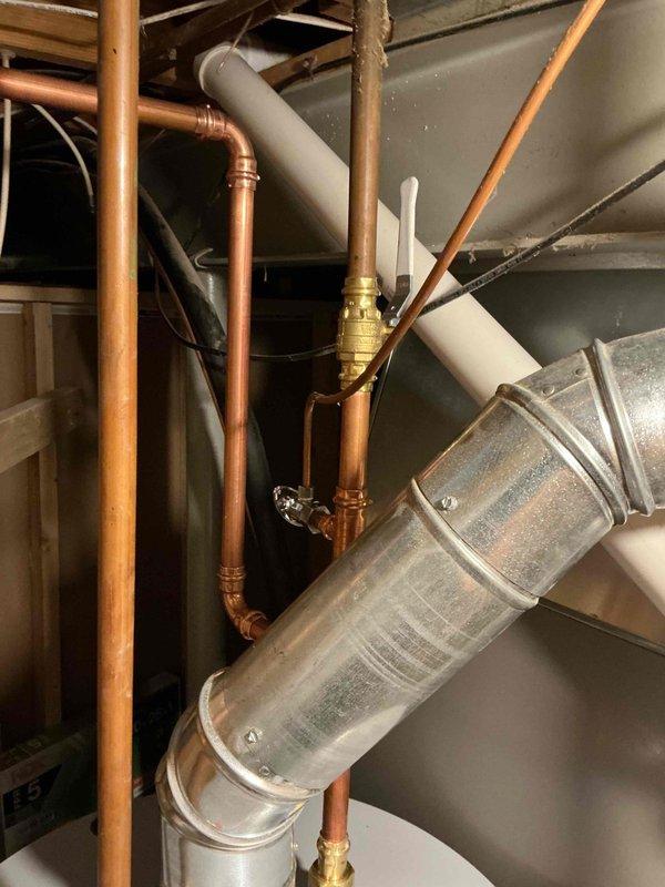 Installed a 50-gallon gas tall water heater in basement utility area with all necessary copper piping connections, brass fittings, and isolation valves. Connected expansion tank to system and verified proper venting through existing galvanized ductwork. All plumbing connections tested and operational upon completion.