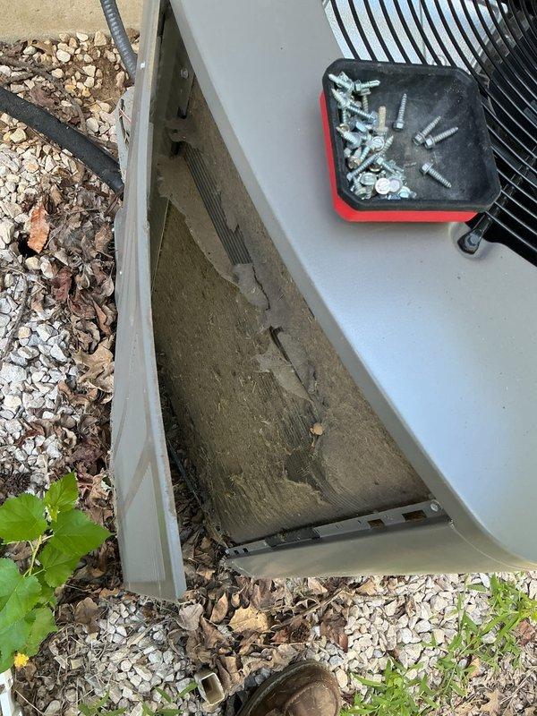 Responded to no cooling complaint with indoor temperature in the 80s. Upon inspection of the 10-year-old outdoor unit, discovered severely clogged air filter restricting airflow to the system. Removed and replaced contaminated filter which was heavily loaded with dust, dirt, and debris. Inspected electrical components including contactor and capacitor, verified all wiring connections secure. System restored to proper cooling operation.
