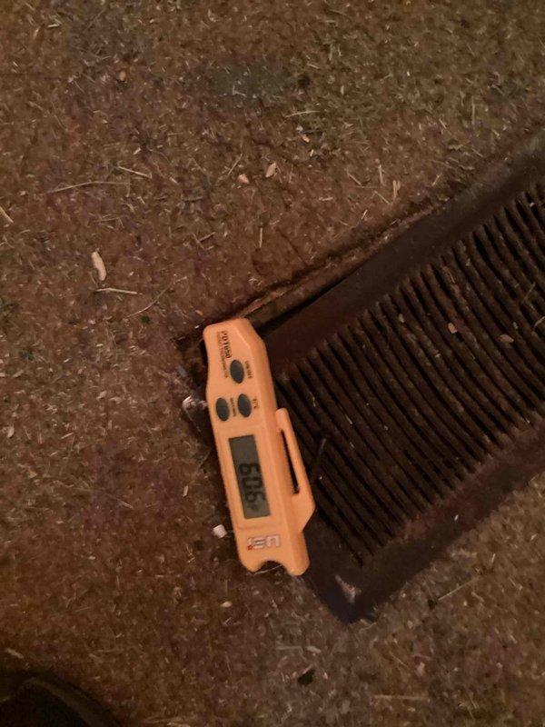Responded to no cooling complaint on a 10+ year old self-contained outdoor AC unit located in backyard. Upon arrival, performed diagnostic evaluation of the condenser unit, which showed visible signs of weathering and corrosion on the top fan grille. Conducted temperature and system performance measurements using digital diagnostic equipment on the condenser coil fins. Initial assessment indicated potential refrigerant deficiency as reported, though further testing was required to determine if leak repair or other mechanical issues were contributing to the cooling failure. Unit had been experiencing extended operational problems. Documented equipment condition with photographs showing the outdoor condenser on concrete pad and close-up diagnostic work on the coil assembly. Customer advised of findings and repair options to restore proper cooling function.