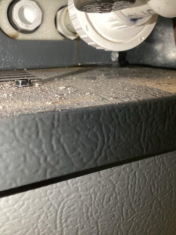 Responded to callback for ongoing water leak beneath furnace in basement. Upon inspection, found condensate drain line assembly showing signs of moisture accumulation and residue buildup around PVC coupling connection. Identified dust and debris accumulation on equipment surfaces, indicating potential drainage obstruction. Inspected drain pan, PVC drain piping, and connection fittings for proper slope and secure attachment. Verified drain line routing and trap configuration to ensure proper condensate removal from 10-year-old unit.