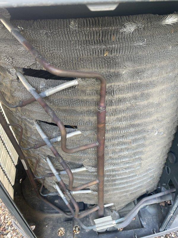 Responded to no cooling call with water accumulation around basement unit. Upon inspection, found evaporator coil heavily soiled with dust and debris restricting airflow, and capacitor showing signs of corrosion and deterioration at terminals. Diagnosed failed capacitor as primary cause of cooling failure, with dirty coil contributing to reduced system efficiency and condensate overflow. Replaced defective capacitor, cleaned evaporator coil, cleared condensate drain line, and verified proper system operation with normal airflow and cooling restored.