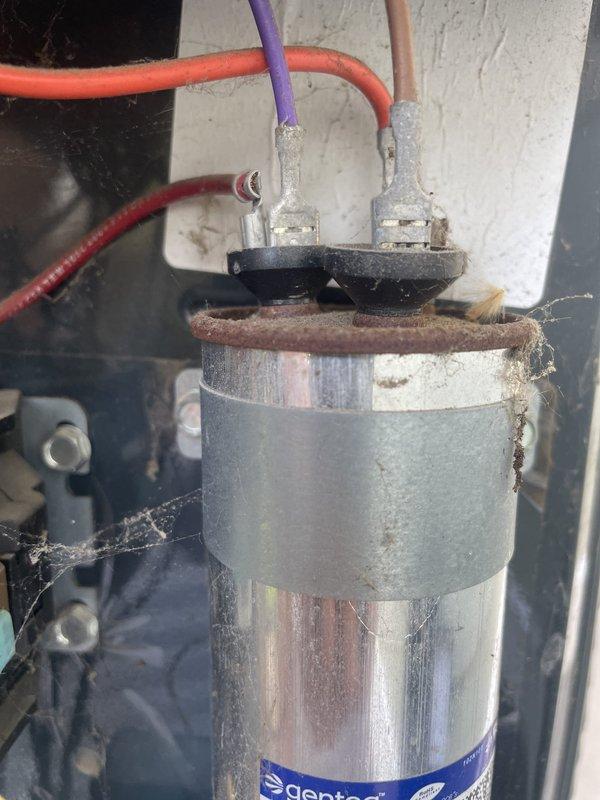 Responded to no cooling call with water accumulation around basement unit. Upon inspection, found evaporator coil heavily soiled with dust and debris restricting airflow, and capacitor showing signs of corrosion and deterioration at terminals. Diagnosed failed capacitor as primary cause of cooling failure, with dirty coil contributing to reduced system efficiency and condensate overflow. Replaced defective capacitor, cleaned evaporator coil, cleared condensate drain line, and verified proper system operation with normal airflow and cooling restored.