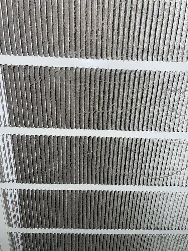 Responded to emergency call for air conditioning unit leaking water through ceiling into living space. Upon inspection, found condensate drain line obstruction causing overflow from drain pan in attic-mounted air handler. Cleared blockage from drain line, verified proper drainage flow, and inspected evaporator coil and drain pan for damage. Replaced heavily soiled air filter which was restricting airflow and contributing to excessive condensation. Checked attic-mounted thermostat and ventilation controls for proper operation. System restored to normal function with no further leakage observed during testing cycle.