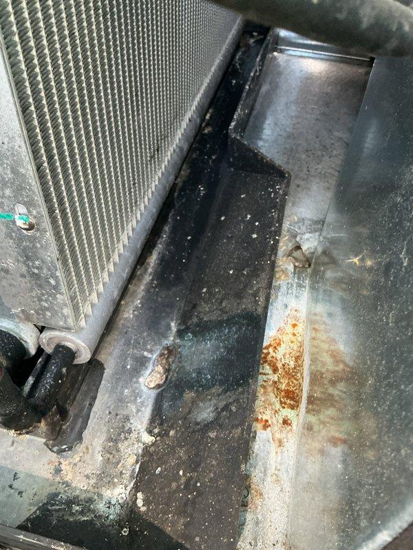 # HVAC Service Call - No Cool Condition

Responded to residential no cooling complaint on 10-year-old air conditioning system. Upon arrival, performed comprehensive diagnostic evaluation of both indoor and outdoor equipment to identify root cause of cooling failure.

## Work Performed

Inspected indoor evaporator coil assembly and found moderate dirt accumulation on coil fins restricting proper airflow and heat transfer efficiency. Examined electrical components including capacitor and wiring connections in air handler, confirming proper voltage and continuity. Noted visible corrosion and rust staining in condensate drain pan indicating previous moisture accumulation and potential drainage concerns.

Assessed refrigerant system components including insulated suction line showing dust buildup but maintaining proper insulation integrity. Verified ductwork connections and flex duct routing for proper air distribution throughout system. Examined control box wiring and connections for signs