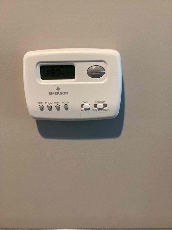 Responded to no cooling complaint on 6-year-old residential air conditioning system. Upon arrival, verified thermostat settings and confirmed system was calling for cooling but unit was not producing cold air. Inspected indoor furnace unit and associated ductwork in utility room. Documented existing equipment configuration including thermostat controls and HVAC components. System evaluation completed and photographic documentation obtained for service records.