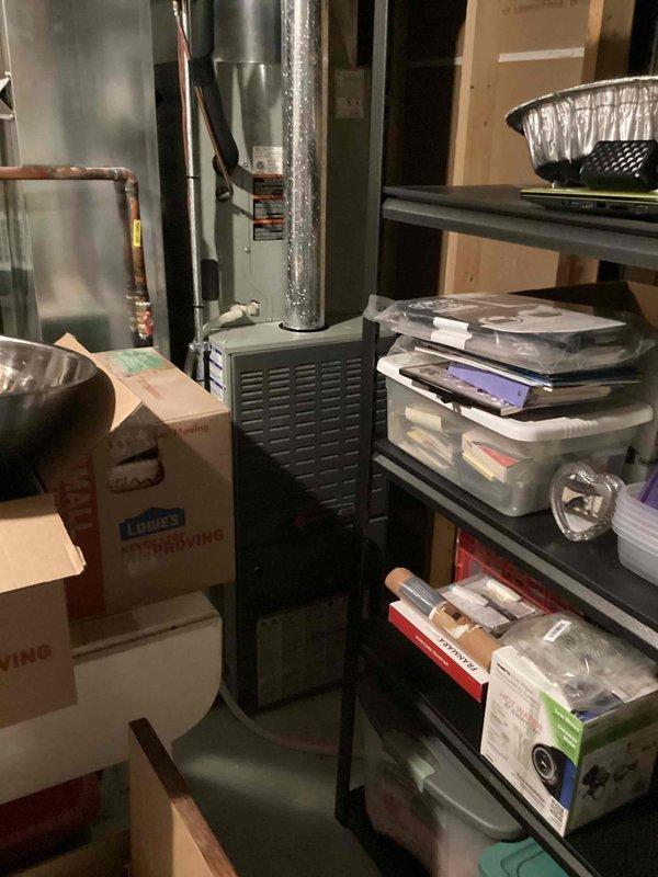 Responded to no cooling complaint on 6-year-old residential air conditioning system. Upon arrival, verified thermostat settings and confirmed system was calling for cooling but unit was not producing cold air. Inspected indoor furnace unit and associated ductwork in utility room. Documented existing equipment configuration including thermostat controls and HVAC components. System evaluation completed and photographic documentation obtained for service records.