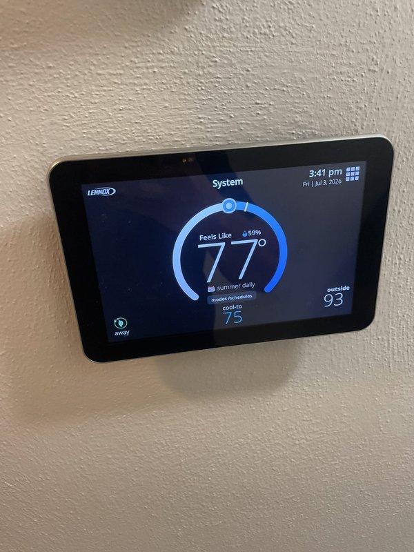 Responded to no cool call on 8-year-old Lennox air conditioning system with smart thermostat display issue. Upon arrival, found AC unit operating but thermostat screen reportedly blank, preventing temperature adjustments. During diagnostic evaluation, thermostat display restored functionality and showed proper operation with touchscreen interface responding normally, displaying current temperature of 77°F, set point of 75°F in cooling mode, and outside temperature of 93°F. Verified thermostat communication with HVAC system, confirmed cooling cycle activation, and tested all control functions including temperature adjustment and mode selection. System operating as designed at time of service completion with full display and control capability restored.