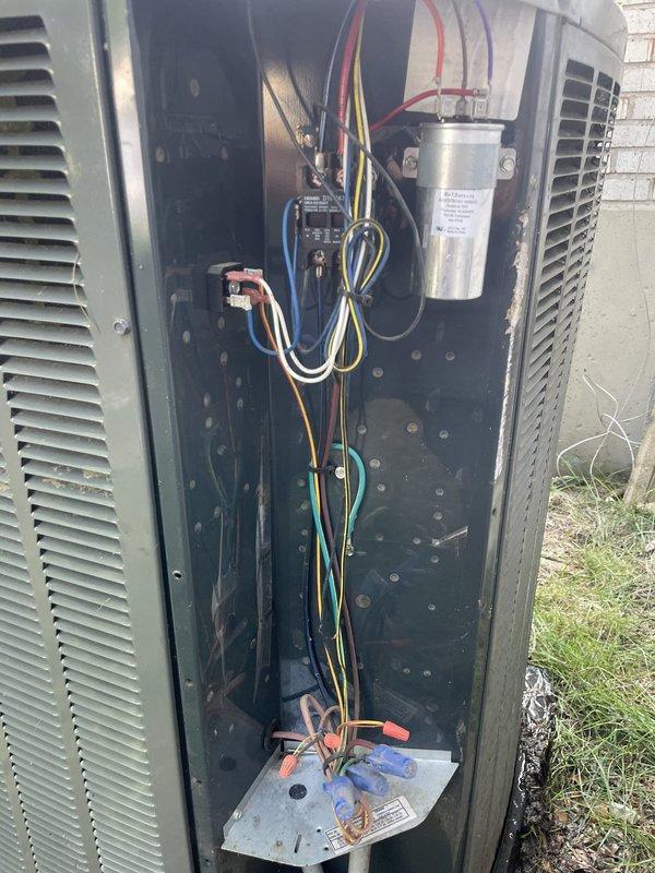 Responded to no cooling complaint on residential system over 10 years old. Upon arrival, confirmed condenser fan motor not operating while compressor attempted to run. Diagnosed failed dual run capacitor showing zero microfarads on both common and fan terminals. Replaced defective capacitor with proper OEM replacement, verified correct wiring connections, and tested system operation. Unit now cooling properly with condenser fan and compressor running within normal parameters.