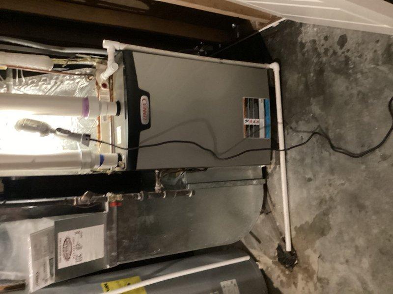 Responded to service call for basement HVAC unit experiencing excessive water leakage. Upon inspection, diagnosed condensate drainage issue and cleared blocked PVC drain line. Verified proper condensate flow, tested system operation, and confirmed no further water accumulation from the air handler unit.