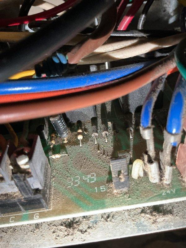 Responded to no cooling call on 20-year-old residential air conditioning system. Upon inspection, found blown fuse on control board due to excessive dust and debris accumulation on circuit board and electrical connections. Replaced failed fuse and cleaned control board and wire terminals. System restored to normal cooling operation. Advised customer that unit's age and condition may result in additional component failures and recommended consideration of system replacement due to equipment being at end of expected service life.