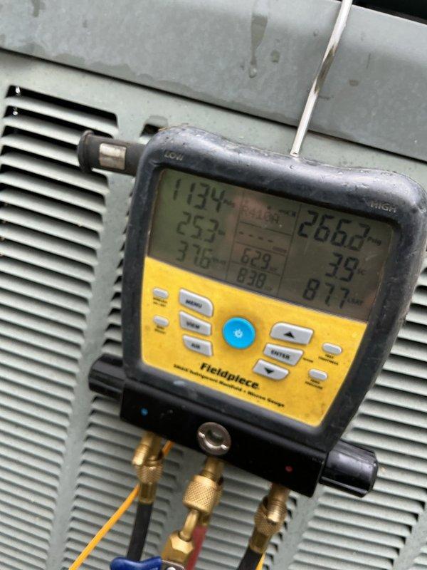 Responded to no cooling complaint on 10+ year old outdoor unit. Upon arrival, found thermostat stuck at 84 degrees with unit off and fan running. Performed diagnostic testing using digital manifold gauges and amp meter to assess system operation. Measured system pressures, temperatures, and electrical parameters at the outdoor condenser unit. Readings indicated suction pressure of 71.6 PSIG, discharge pressure of 258 PSIG, with superheat at 25.2 degrees and subcooling at 39 degrees. Evaluated compressor amperage draw and overall system performance to determine root cause of cooling failure.