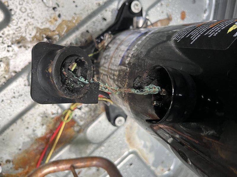 # HVAC Service Call Completion Report

Responded to callback for reported compressor failure on air conditioning system. Upon arrival, confirmed complete compressor failure with catastrophic internal damage. Visual inspection revealed extensive electrical terminal corrosion with green and white oxidation buildup at connection points, indicating prolonged moisture intrusion. Compressor housing exhibited severe external deterioration, rust staining, and compromised wiring connections.

Assessment identified failed run capacitor with vertical cracking along casing and separated insulation material, contributing to system failure. Capacitor damage rendered component non-functional and required immediate replacement. Collected payment and completed system replacement per customer authorization. Advised customer to shut off AC unit and operate fan only until repairs were finalized to prevent further damage. Documented equipment condition with photographic evidence showing corrosion damage, f