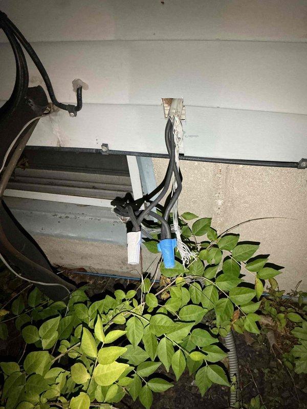 Technician arrived on-site for scheduled service call but job was cancelled after dispatch. Documentation photos were captured showing existing HVAC electrical components including capacitor/contactor assembly with multi-conductor wiring harness mounted to weathered metal panel, and auxiliary electrical connections with conduit routing in mechanical area.
