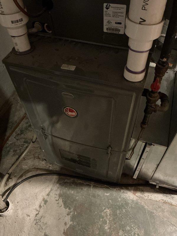 Completed preventative maintenance tune-up on two 10-year-old cooling systems: one ground-level outdoor unit and one attic-mounted unit. Performed comprehensive inspections including filter checks, refrigerant level verification, electrical connection testing, condensate drain line evaluation, and coil cleaning on both systems. Noted significant discoloration and potential microbial growth visible behind return air grille, indicating possible moisture intrusion or indoor air quality concerns that may require further investigation. Both units operational upon completion of scheduled maintenance service.