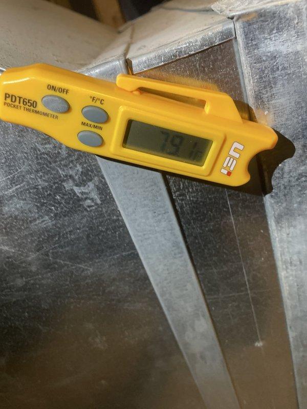 Responded to no cooling complaint on upstairs Lennox air conditioning unit approximately 10-12 years old located in attic space. Upon arrival, performed system diagnostics and temperature measurements using calibrated digital thermometer on supply ductwork. Inspected air handler unit, ductwork connections, and flexible duct runs for proper airflow and system operation. Documented equipment condition and attic installation with photos showing main supply plenum, metal ductwork assembly mounted on floor joists, and insulated flex duct distribution. Verified system specifications and confirmed unit is covered under 2-year equipment warranty with compressor manufacturing date of 2022.