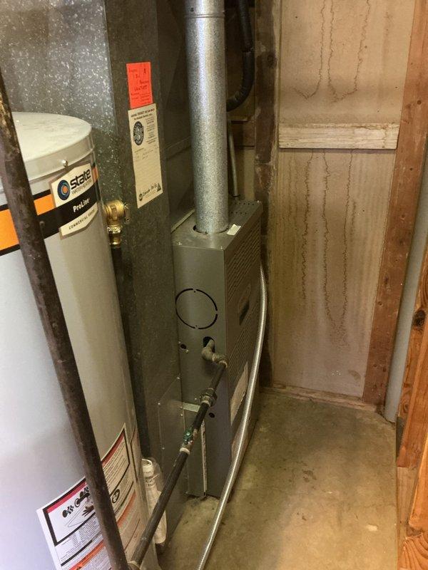 Responded to no cooling complaint on 19-year-old Lennox air conditioning system installed in 2006. Upon inspection, performed diagnostic evaluation of the aged unit to determine cause of cooling failure. Documented equipment condition and installation configuration including basement-mounted furnace and associated ductwork distribution system.
