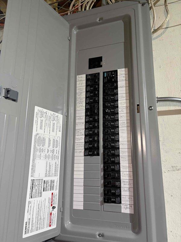 Completed electrical panel replacement with installation of new circuit breaker panel box and organized circuit distribution system. Installed surge protection device to safeguard electrical system from voltage spikes and power surges. All circuits were properly labeled, connections secured, and panel mounted to exterior wall with appropriate conduit routing for service entrance conductors.