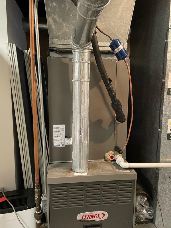 Completed evaporator coil replacement on Lennox HVAC system with serial number 6007E13300. Removed failed coil and installed new coil assembly, reconnected refrigerant lines, and verified proper drainage through condensate pan and PVC drain line. System tested and confirmed operational for both heating and cooling modes.