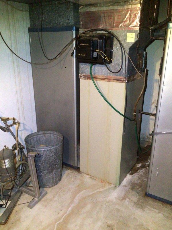 Performed comprehensive diagnostic on upstairs HVAC unit addressing no airflow from supply vents. Inspected downstairs unit for reported water discharge issue, identifying active condensate drainage concerns and evidence of previous moisture damage to basement floor and surrounding areas. Documented system conditions with photos showing both furnace installation and water heater/HVAC equipment configuration, noting staining patterns on concrete floor and copper piping connections requiring attention.