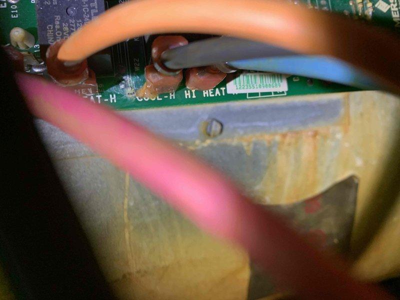 Responded to no-cool call on 10+ year old unit in side yard where breaker had tripped and water was pooling under equipment with frozen coil. Upon arrival, found evidence of drainage issues causing water accumulation and ice formation on evaporator coil. Inspected control board wiring and electrical connections, identifying compromised wire terminals with visible corrosion on housing panel. Performed electrical diagnostics and rewired control board connections using proper wire nuts to ensure secure terminations. Addressed drainage blockage causing water backup and verified all electrical connections were properly secured to prevent future tripping. Unit restored to normal operation with proper cooling function and drainage flow confirmed.