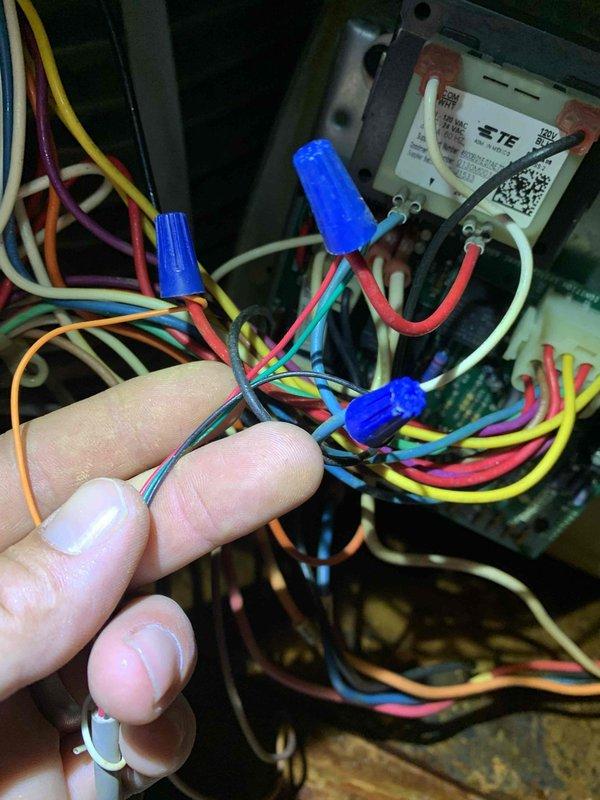 Responded to no-cool call on 10+ year old unit in side yard where breaker had tripped and water was pooling under equipment with frozen coil. Upon arrival, found evidence of drainage issues causing water accumulation and ice formation on evaporator coil. Inspected control board wiring and electrical connections, identifying compromised wire terminals with visible corrosion on housing panel. Performed electrical diagnostics and rewired control board connections using proper wire nuts to ensure secure terminations. Addressed drainage blockage causing water backup and verified all electrical connections were properly secured to prevent future tripping. Unit restored to normal operation with proper cooling function and drainage flow confirmed.