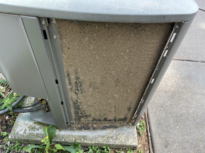 Responded to no-cool service call on 2017 Lennox air conditioning system. Upon arrival, obtained homeowner permission before proceeding with diagnostics. Inspection revealed extremely dirty and clogged air filter causing restricted airflow to the system. Filter showed heavy accumulation of dust, dirt, and debris with significant discoloration throughout. Top screen and mesh components also found obstructed with debris. Removed and replaced severely soiled filter. Cleaned debris from unit exterior and surrounding area where vegetation and organic matter had accumulated near equipment. Verified proper airflow restoration after filter replacement. System returned to normal cooling operation with improved air circulation and accurate temperature readings.