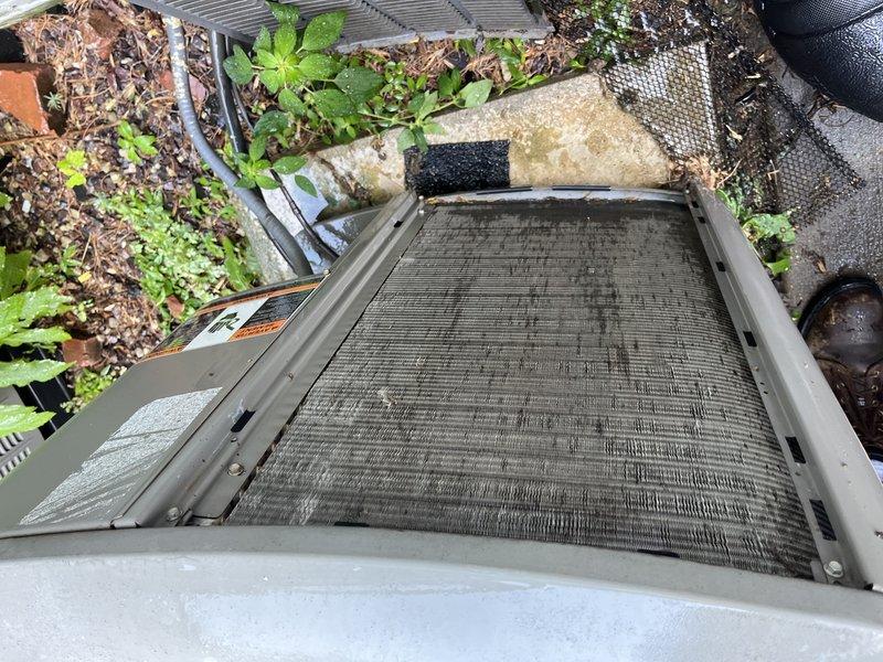 Responded to no-cool service call on 2017 Lennox air conditioning system. Upon arrival, obtained homeowner permission before proceeding with diagnostics. Inspection revealed extremely dirty and clogged air filter causing restricted airflow to the system. Filter showed heavy accumulation of dust, dirt, and debris with significant discoloration throughout. Top screen and mesh components also found obstructed with debris. Removed and replaced severely soiled filter. Cleaned debris from unit exterior and surrounding area where vegetation and organic matter had accumulated near equipment. Verified proper airflow restoration after filter replacement. System returned to normal cooling operation with improved air circulation and accurate temperature readings.