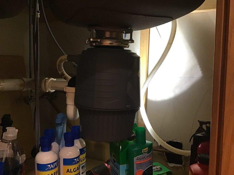 Supplied and installed a 50-gallon tall gas water heater in the basement, including necessary gas valve and fittings with flexible 3/8" copper gas flare connections and existing flexible exhaust. Installed 3/4" pressure reducing valve and secured all gas piping to concrete wall per code requirements. Applied for and obtained plumbing permit 26PLU-13662 with proper identification sticker affixed to installation. Additionally addressed kitchen plumbing issue by inspecting and clearing dishwasher drain line connected to garbage disposal assembly under sink.