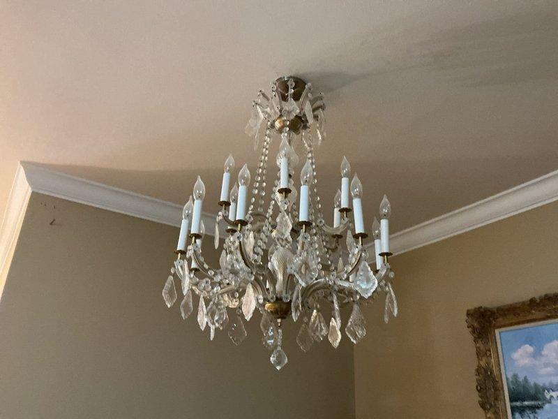 Responded to reported non-functional crystal chandelier and inoperative light switch on first floor, along with a separate lighting issue on the second floor. Performed electrical troubleshooting at the main breaker panel to identify circuit assignments and verified proper breaker operation for affected areas. Inspected the multi-tier chandelier fixture with candle-style lamps, tested switching circuits, and restored power to all reported lighting fixtures.