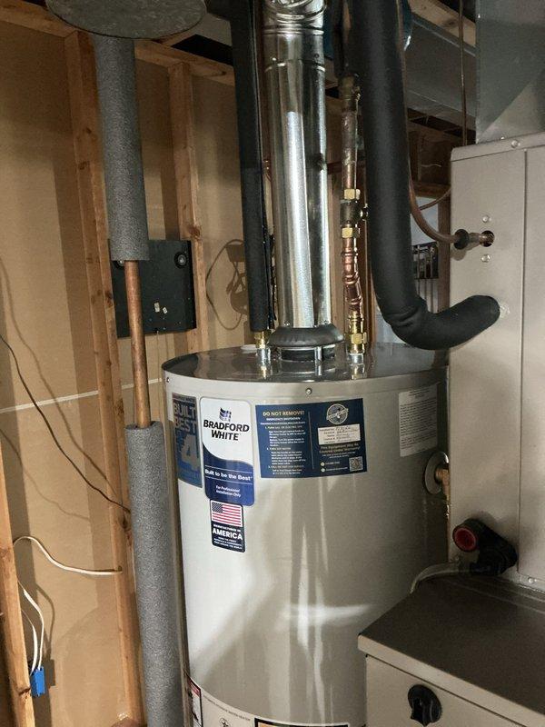 Installed 50-gallon gas tall water heater in basement to resolve no hot water condition. Connected all water supply lines, gas piping, and venting per code requirements under permit #26PLU-13661. Applied required plumbing identification sticker and verified proper operation of new Bradford White unit with extended warranty coverage.