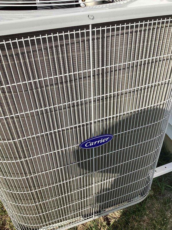 Completed comprehensive tune-up service on Carrier outdoor air conditioning unit. Performed standard maintenance inspection, verified system operational parameters using digital clamp meter with readings of 124V and 62A, and confirmed unit is operating within manufacturer specifications. Unit exterior and condenser coil grille are in clean, well-maintained condition with no visible damage or deterioration noted.