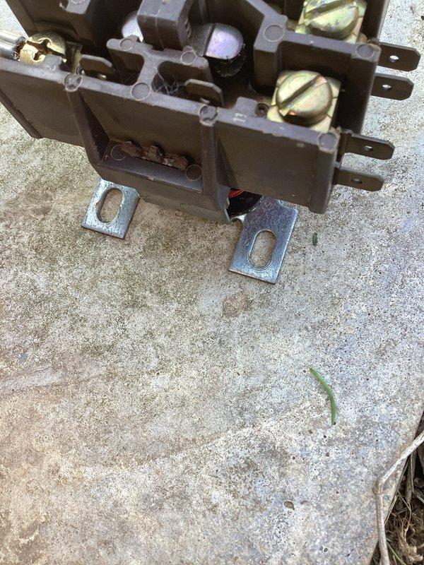 Responded to service call for cooling system blowing warm air on unit over 10 years old located in side yard. Upon inspection, found failed contactor preventing compressor operation. Removed defective contactor from unit, installed replacement contactor, verified all electrical connections at terminal block were secure, and tested system operation. Unit now cooling properly with compressor engaging as designed.