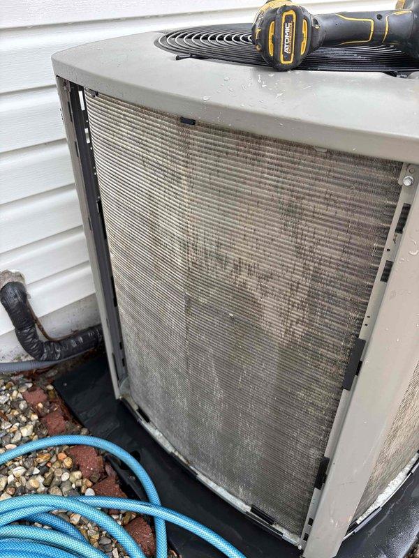 Responded to customer complaint of AC unit making repeated "revving up" noises in a cycling pattern while still maintaining cooling capacity. Upon inspection of 2-year-old Lennox system, found outdoor condenser unit's intake grille and filter heavily restricted with dust, dirt, and debris accumulation. Restricted airflow was causing compressor to cycle on high-pressure cutout as unit struggled to maintain adequate heat exchange. Removed and cleaned condenser filter, cleared debris from intake grille mesh screening. Verified proper airflow restoration through condenser coil. Cycled unit through multiple cooling cycles to confirm elimination of abnormal sound patterns and return to normal operating parameters.