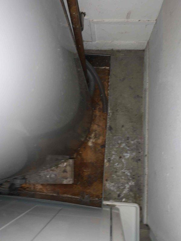 Responded to recall for improper condensate drain installation from previous service visit. Upon arrival, found condensate line had been incorrectly routed into water heater drain pan, causing AC unit malfunction. Corrected condensate drain routing to proper discharge location away from water heater, verified system operation, and confirmed unit returned to normal cooling function.