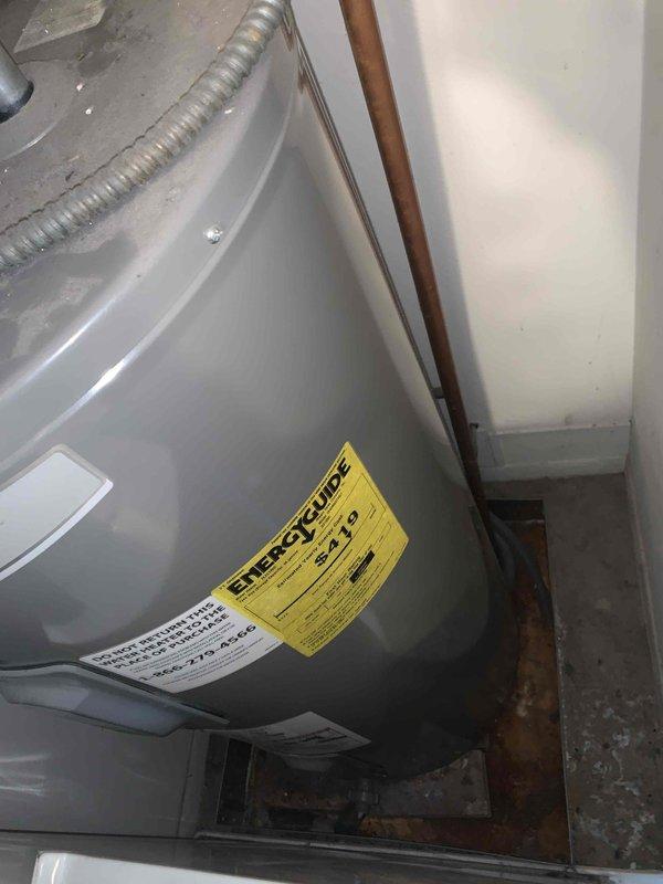 Responded to recall for improper condensate drain installation from previous service visit. Upon arrival, found condensate line had been incorrectly routed into water heater drain pan, causing AC unit malfunction. Corrected condensate drain routing to proper discharge location away from water heater, verified system operation, and confirmed unit returned to normal cooling function.