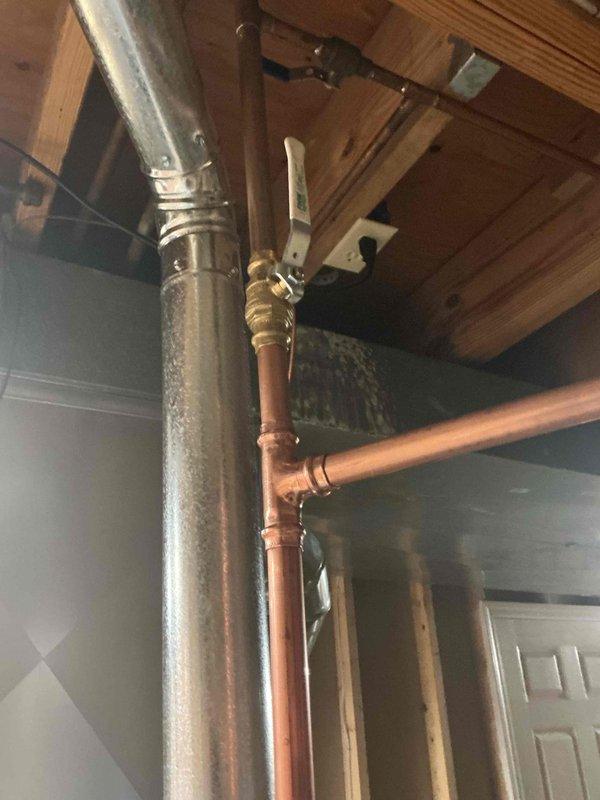 Installed a 40-gallon State ProLine commercial-grade gas water heater in basement utility area with complete copper piping connections, brass shut-off valves, and proper venting through metallic duct system. Connected unit to existing pressure tank system with appropriate compression fittings and integrated galvanized supply lines with copper distribution piping using brass transition fittings and ball valves for system isolation.