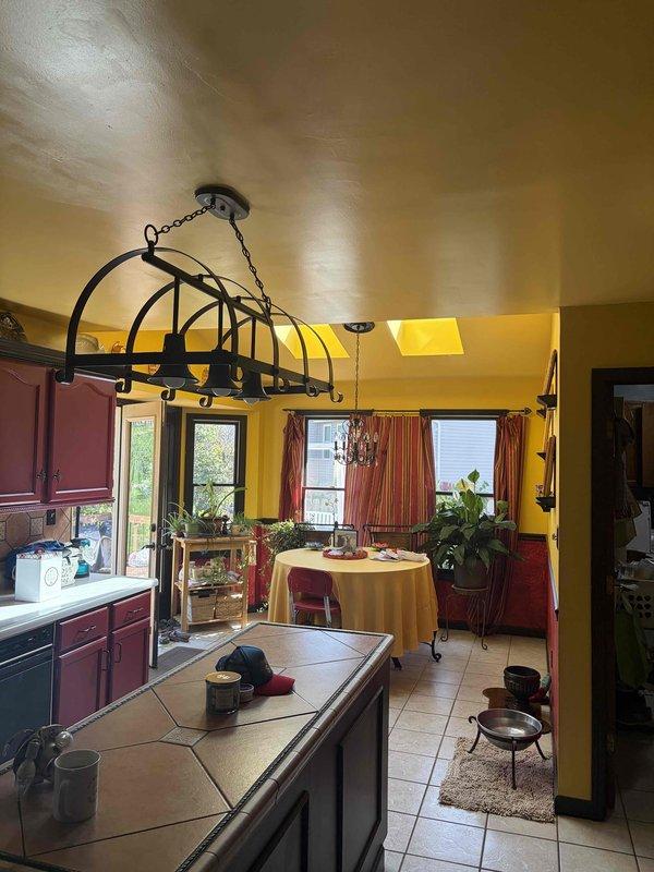 Responded to service call for non-functional ceiling fan and light fixture in residential kitchen area. Upon inspection, diagnosed electrical issue affecting the ceiling fan unit with wooden blades and integrated lighting. Performed necessary troubleshooting and repairs to restore power and functionality to both the fan motor and light components. Verified proper operation of pull chain controls and confirmed unit was operating safely before completing service.