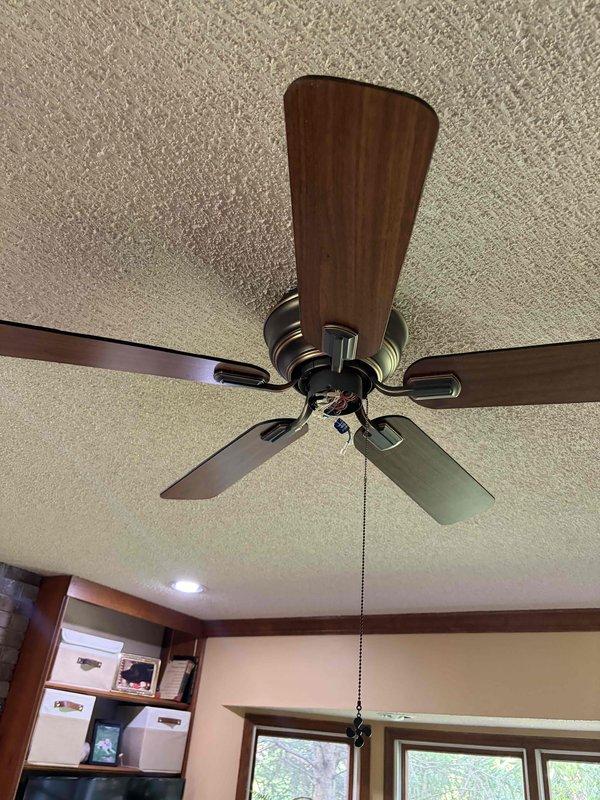 Responded to service call for non-functional ceiling fan and light fixture in residential kitchen area. Upon inspection, diagnosed electrical issue affecting the ceiling fan unit with wooden blades and integrated lighting. Performed necessary troubleshooting and repairs to restore power and functionality to both the fan motor and light components. Verified proper operation of pull chain controls and confirmed unit was operating safely before completing service.