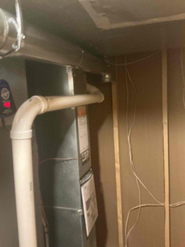 Addressed water heater flue installation and provided technical consultation regarding flue liner requirements. After thorough inspection and assessment of the existing HVAC system and water heater configuration, determined that flue liner installation was not necessary for this application. Responded to customer inquiries and concerns about proper venting requirements, explaining code compliance and safety considerations. Documented equipment condition and current installation with photographs showing air handler unit, condensing unit with refrigerant lines, PVC condensate drainage, and furnace with existing vent piping configuration in mechanical space.