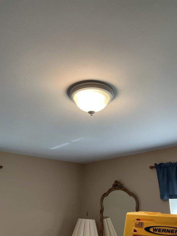 Installed customer-provided flush-mount ceiling light fixture in bedroom, including electrical connections, secure mounting to ceiling junction box, and verification of proper operation. Additional work was completed as requested on-site.