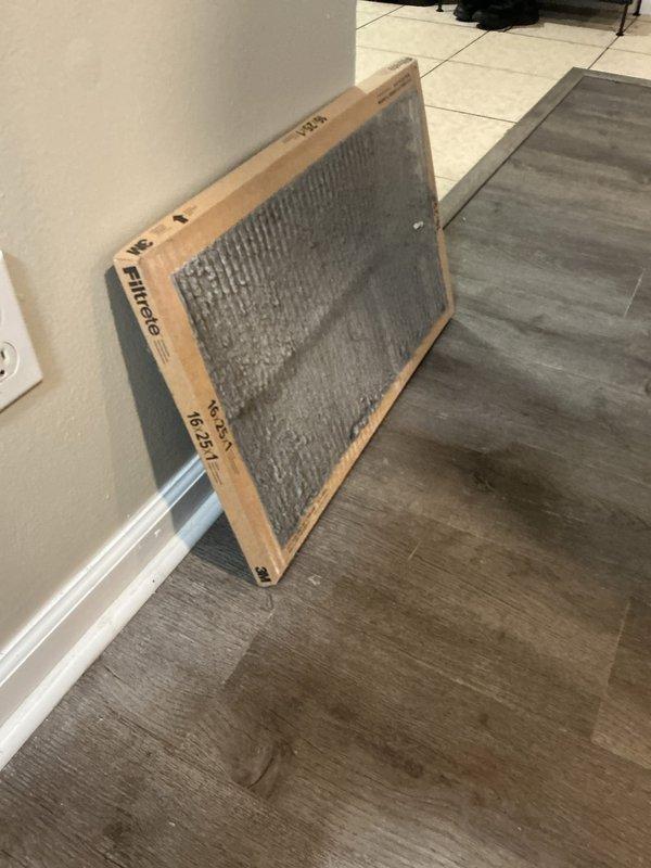 Completed comprehensive tune-up service on a 10-year-old residential air conditioning unit located at the rear of the property. Performed standard maintenance protocol including system inspection, component testing, and replaced heavily soiled 16x25 Filtrete air filter that showed significant dust and debris accumulation. Unit exterior showed weathering and surface staining but operated within normal parameters upon completion of service.