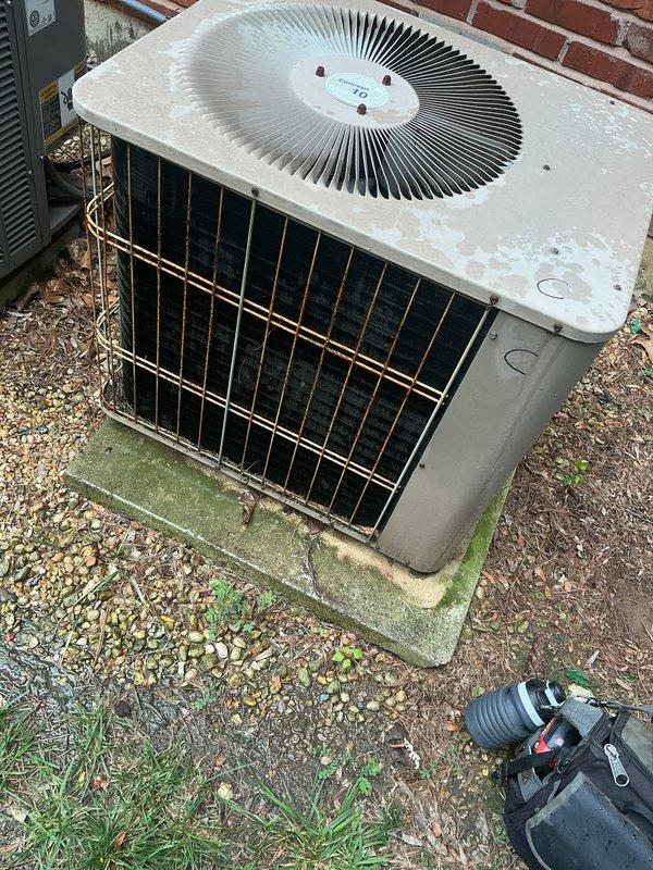 Completed comprehensive tune-up service on a 10-year-old residential air conditioning unit located at the rear of the property. Performed standard maintenance protocol including system inspection, component testing, and replaced heavily soiled 16x25 Filtrete air filter that showed significant dust and debris accumulation. Unit exterior showed weathering and surface staining but operated within normal parameters upon completion of service.
