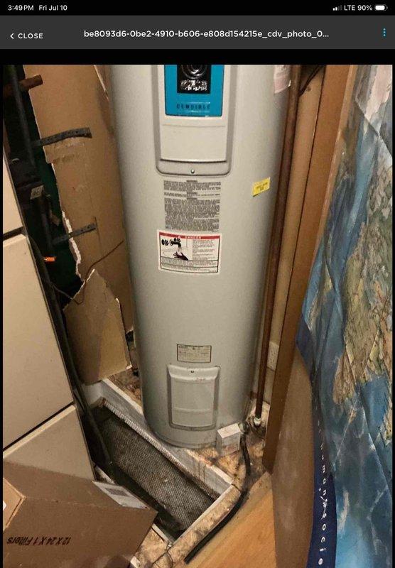 Installed a 40-gallon electric State ProLine Commercial Grade tanked water heater in utility closet. Unit positioned on white drain pan per code requirements, with all copper supply line connections and brass fittings properly secured at top of tank. Installation completed with digital control panel operational and all manufacturer labels intact for future reference.
