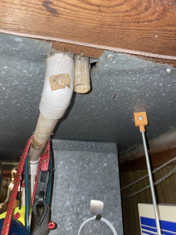 Responded to service call for multiple water leak issues affecting 16-year-old HVAC system and boiler. Conducted comprehensive inspection of air conditioning unit, boiler piping system, and plumbing fixtures. Identified active leak in boiler pipe connection beneath flooring in basement utility area, with evidence of water damage and aging PVC piping requiring attention. Inspected AC condensate drainage system and evaporator coil area for source of reported air conditioning leak. Documented conditions of all affected systems through photographic evidence showing deteriorated piping, worn connections, and water intrusion points. Assessed toilet fixture reported as malfunctioning during same visit. Provided detailed estimates for both repair options and full system replacement alternatives to allow customer comparison of solutions for aging equipment.