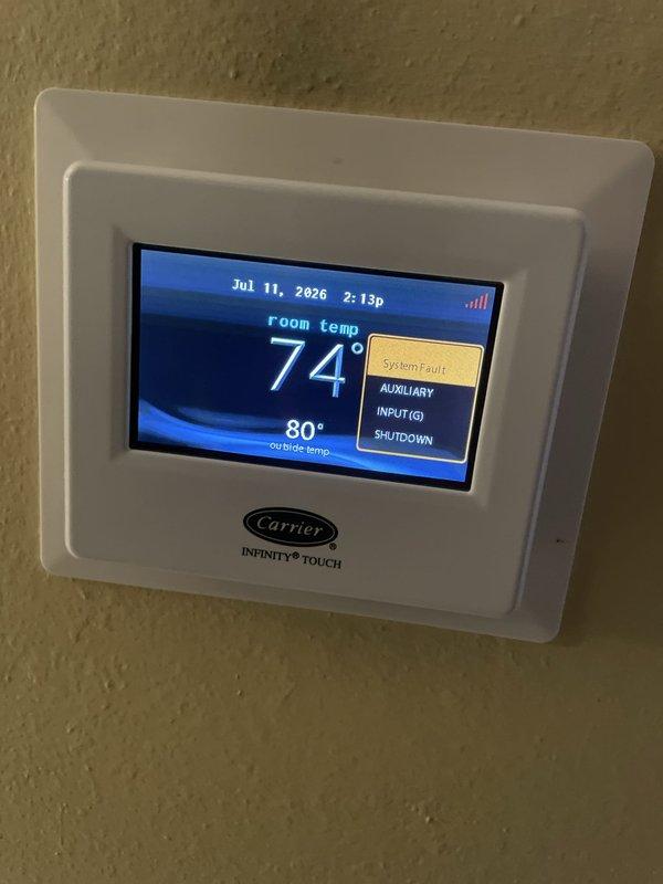 Responded to no cooling call on 10+ year old Carrier system with Infinity Touch thermostat displaying error code 196 (auxiliary input G shutdown fault). Diagnosed intermittent system cycling issue caused by faulty auxiliary input signal triggering safety shutdown. Cleared fault code, tested system operation through multiple cooling cycles, and verified proper communication between thermostat and air handler to restore normal cooling function.