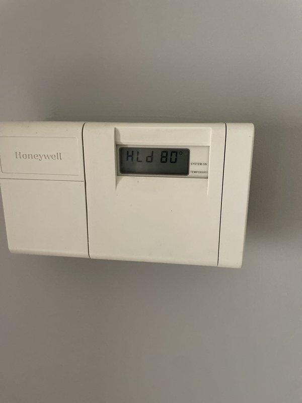 Responded to emergency service call for non-cooling residential air conditioning system. Connected manifold gauge set to measure R-410A refrigerant pressures and confirmed low refrigerant charge. Added refrigerant to system to restore temporary cooling capacity while customer awaits scheduled equipment replacement, bringing system pressures within acceptable operating range and restoring functionality to thermostat.