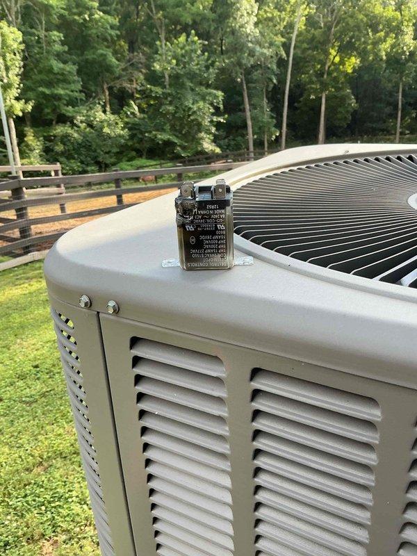 Responded to no cooling complaint on 10+ year old Lennox residential air conditioning system located on side of home. Upon arrival, found outdoor condenser unit not operating while indoor fan was running as instructed. Performed diagnostic evaluation of electrical components and refrigerant system. Identified failed component preventing compressor operation. Replaced defective relay/contactor assembly, restored power to compressor, and verified proper system operation with normal cooling restored.